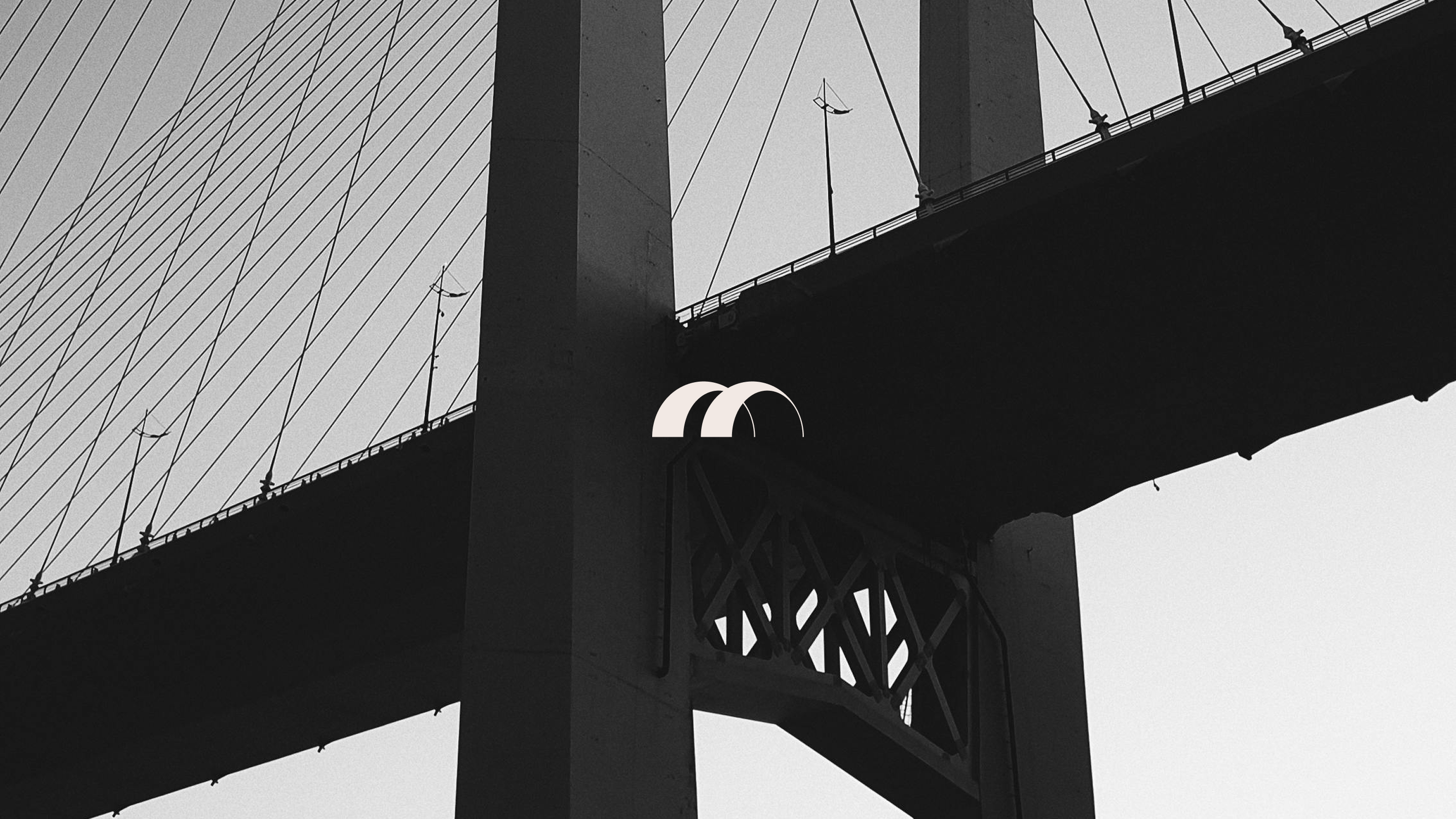 Suspension bridge with Brenman arch logo